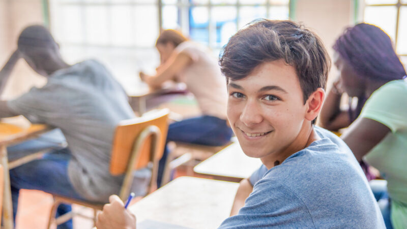 Confident,Caucasian,Teenager,Boy,In,The,Classroom,Doing,School,Test.